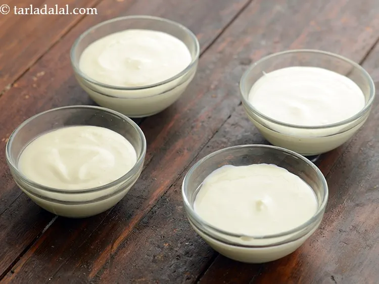 Step 6 – Pour the <strong>bhappa doi</strong> mixture into 12 small microwave-safe bowls.&nbsp;