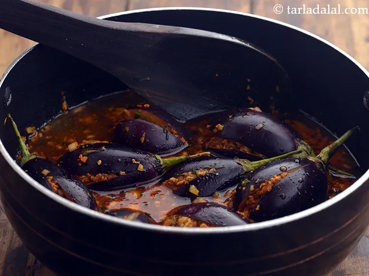 Step 25 – Mix gently or else the stuffed brinjals will break.