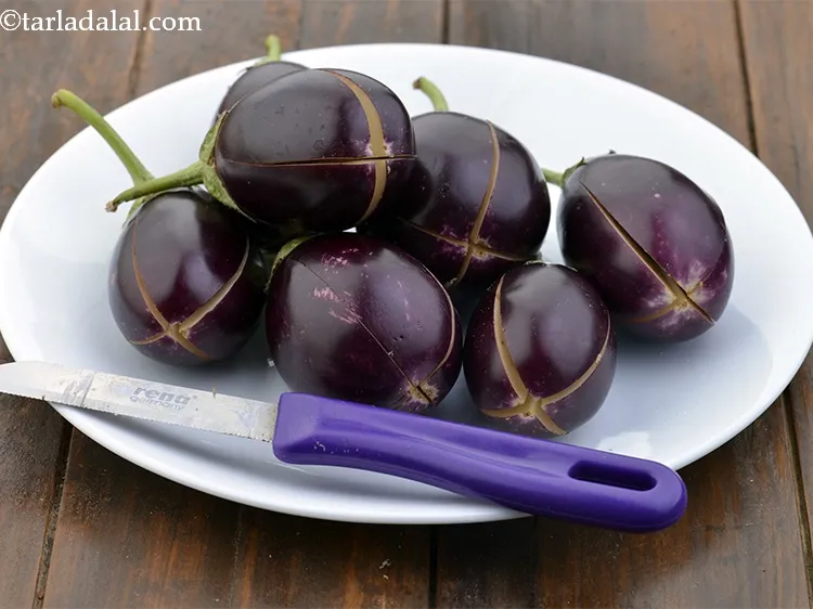 Step 16 – Make a criss-cross slit on each brinjal taking care not to separate the segments.