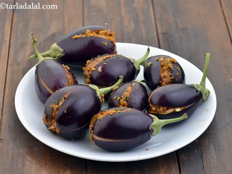 Step 17 – Stuff each brinjal evenly with the prepared masala mixture and keep the remaining mixture aside …
