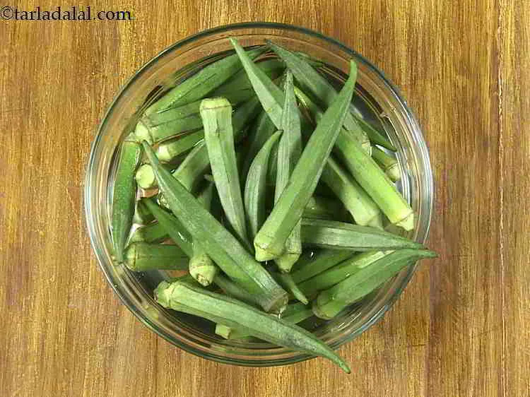 Step 2 – To make <strong>Bhindi Masala Gravy</strong>, first wash the bhindi and place them on a kitchen …
