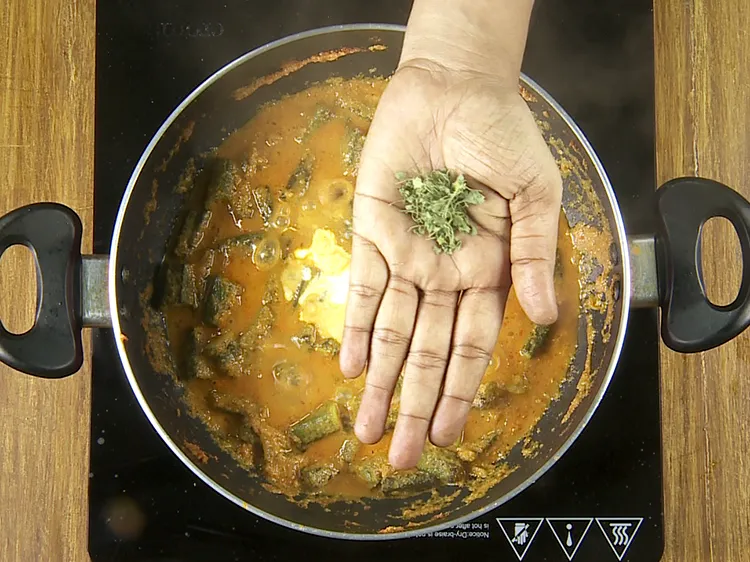 Step 31 – Add the dried fenugreek leaves to&nbsp;<strong>&nbsp;Bhindi Masala Gravy</strong>. Crush the dried fenugreek leaves between your …