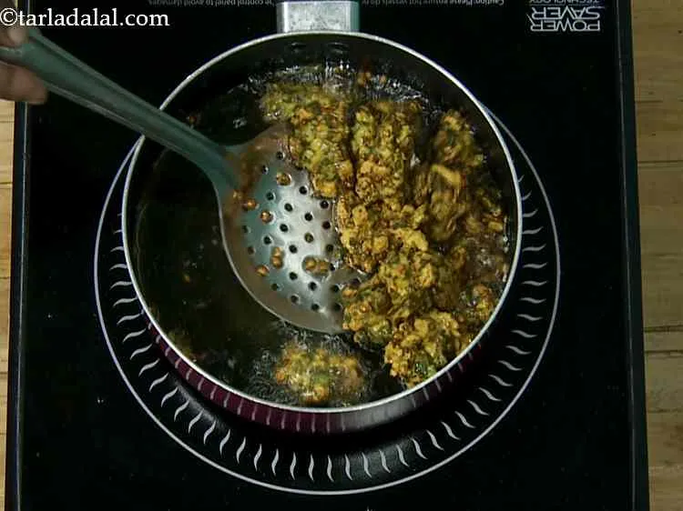 स्टेप 13 – मध्यम आंच पर एक बार में कुछ पकोड़े को डीप-फ्राई …