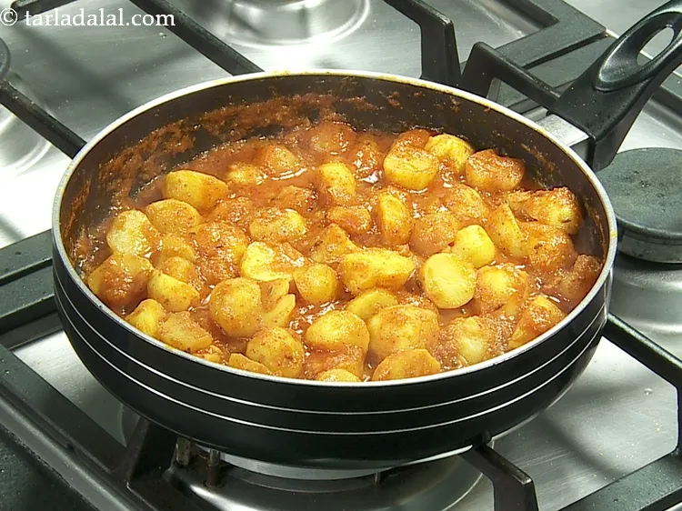 Step 24 – Mix well gently and cook on a medium flame for 5 minutes while stirring occasionally.