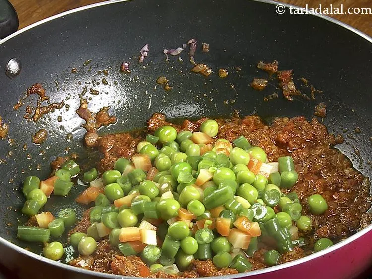Step 12 – Add boiled mixed vegetables. We have used carrot, French beans, green peas which have been …