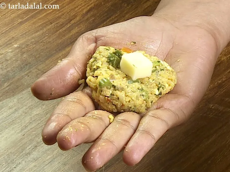 Step 30 – Place a cheese cube in the center of the round. We have used mozzarella cheese …