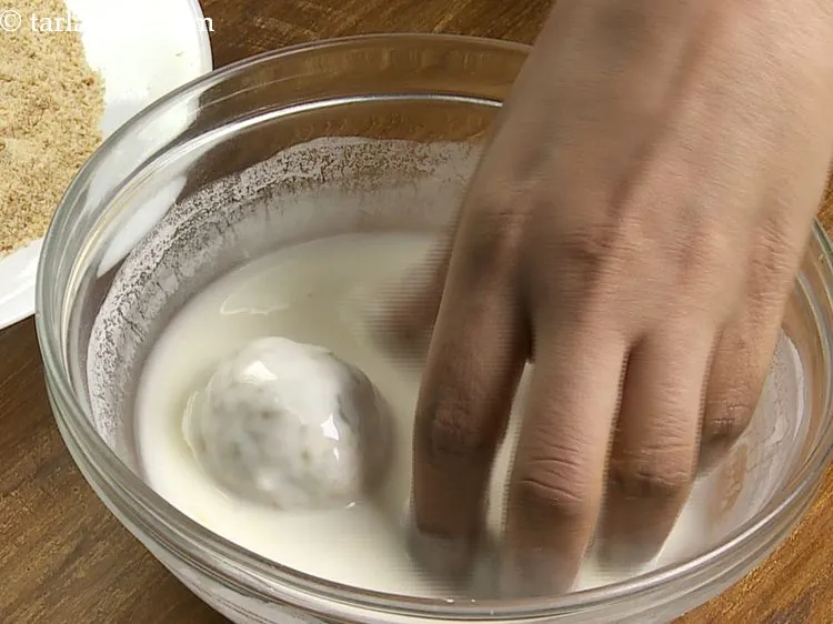 Step 32 – Dip a ball in the plain flour-water mixture. Always dip the arancini in the flour …