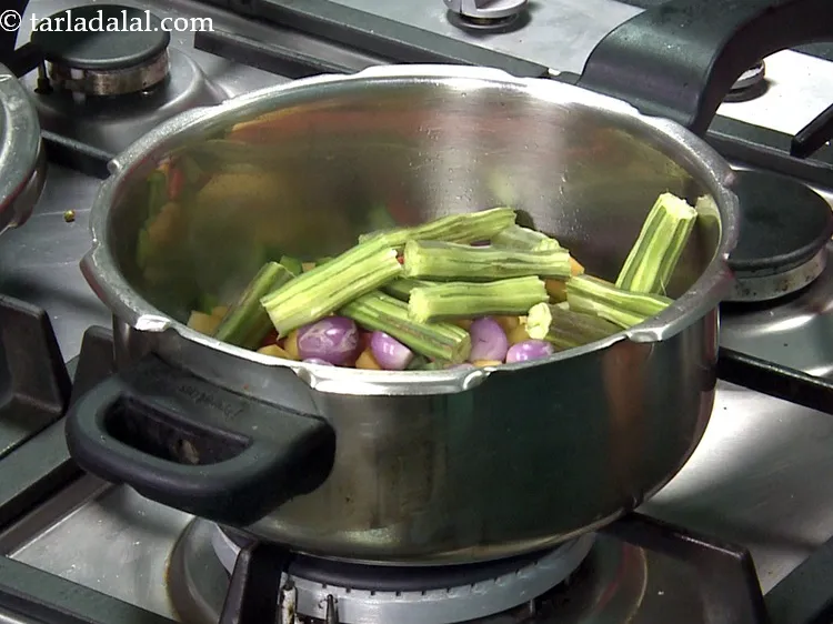 Step 34 – Add 1/2 cup&nbsp;<a href="https://www.tarladalal.com/glossary-drumstick-pieces-2374i">drumstick pieces</a>.