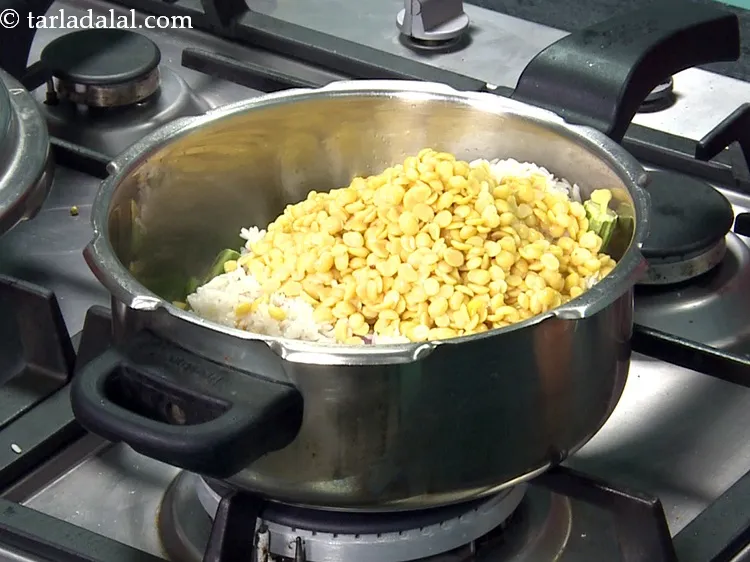 Step 36 – Add 1/2 cup&nbsp;<a href="https://www.tarladalal.com/glossary-toovar-dal-arhar-dal-toor-dal-split-pigeon-peas-tur-dal-955i">toovar (arhar) dal</a>, soaked for 30 minutes and drained.