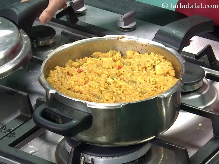 Step 44 – Mix well and pressure cook for 4 whistles. Allow the steam to escape before opening …