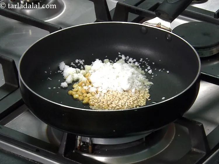 Step 9 – Add 1/4 cup&nbsp;<a href="https://www.tarladalal.com/glossary-grated-coconut-852i">grated coconut</a>.