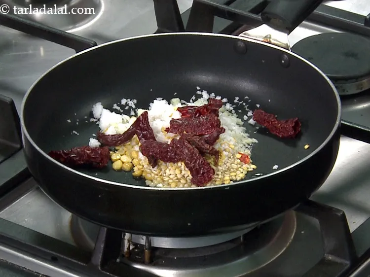 Step 10 – Add 5&nbsp;<a href="https://www.tarladalal.com/glossary-whole-dry-kashmiri-red-chillies-kashmiri-mirch-kashmiri-lal-mirch-332i">whole dry kashmiri red chillies</a>&nbsp;, broken into pieces.