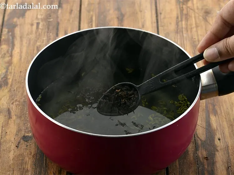 Step 15 – Turn the flame off and add the tea leaves .