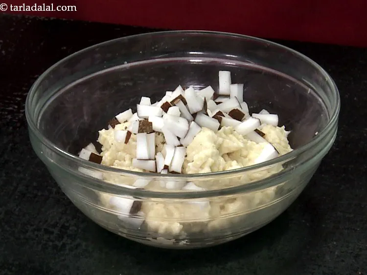 Step 11 – <p>Add ¼ cup chopped fresh coconut. They give a nice bite to the soft bonda.</p>