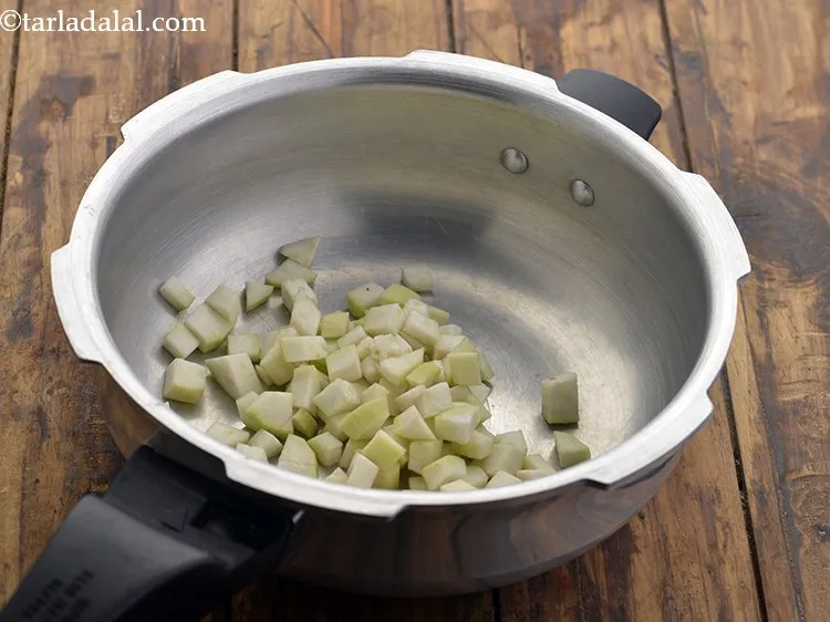 Step 21 – Now take a clean pressure cooker and add the chopped bottle gourd.&nbsp;&nbsp;