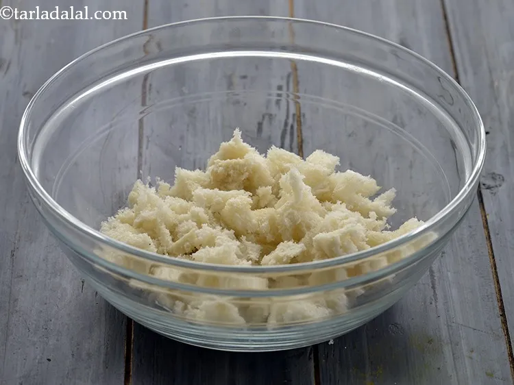 Step 4 – Tear the bread into very small pieces and add into a deep bowl.