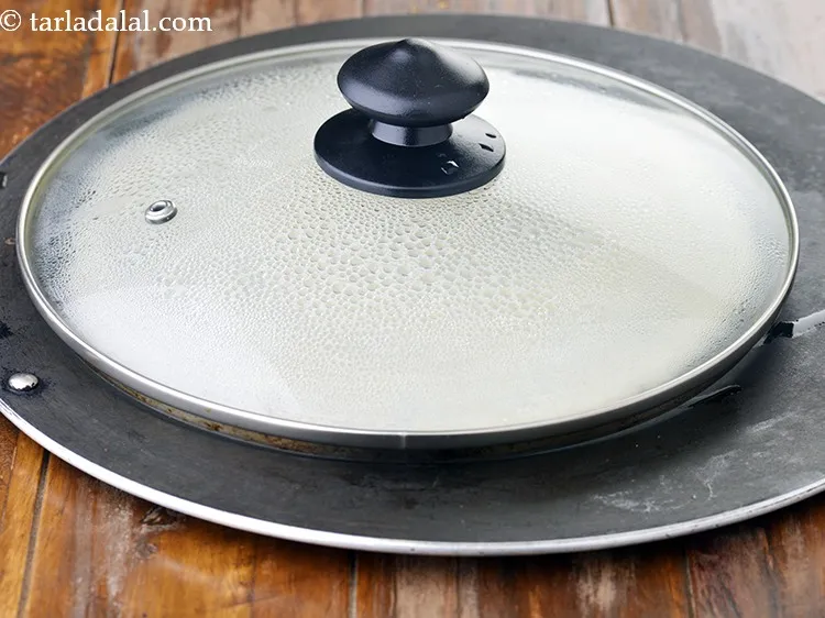 Step 13 – Cover it with a lid and cook on a medium flame for 2 minutes.