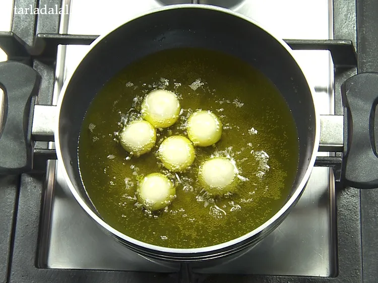 Step 25 – Add a few balls at a time in hot ghee.