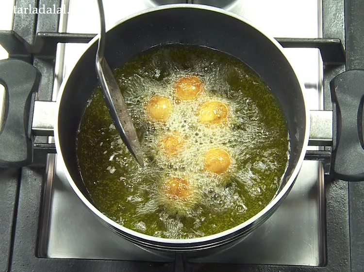 Step 34 – Deep fry on a slow to medium flame so the bread gulab jamuns get uniformly …