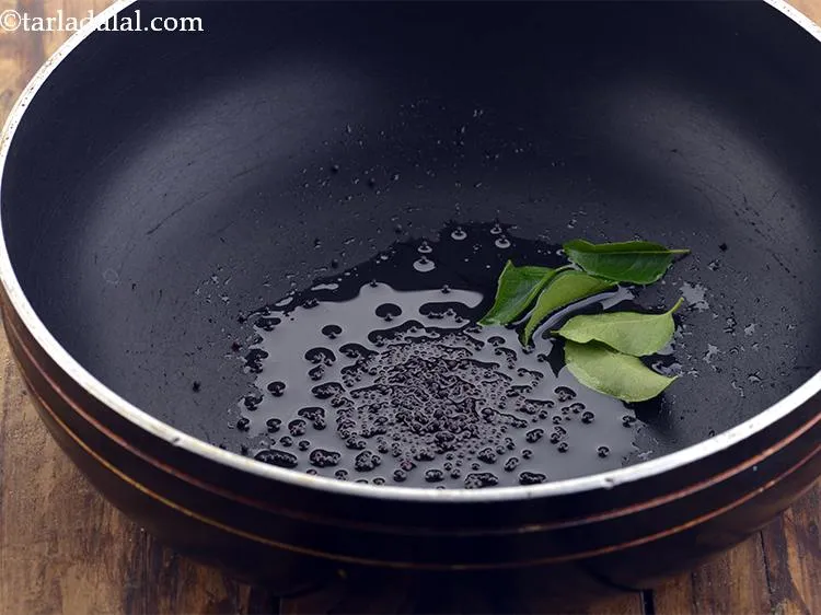 Step 3 – Add the curry leaves and let them infuse their flavor into the oil.