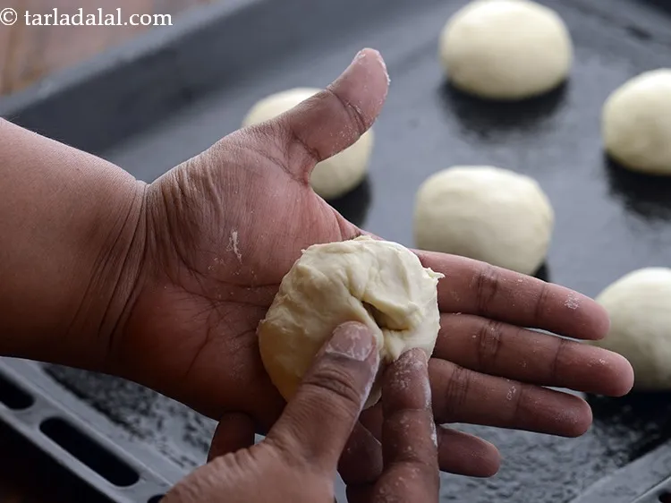 Step 16 – Take a portion of dough and stretch the top of the dough while pinching and …