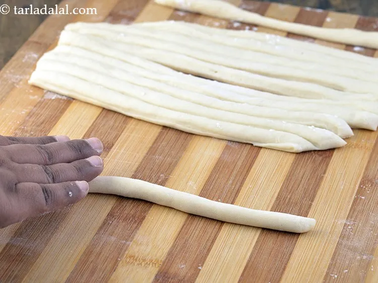 Step 17 – Take a portion and roll it lightly on the surface without using any plain flour …