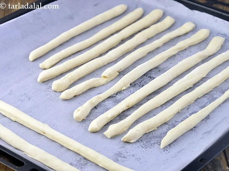 Step 19 – Place all the rolled portions on a baking tray lined with butter paper.