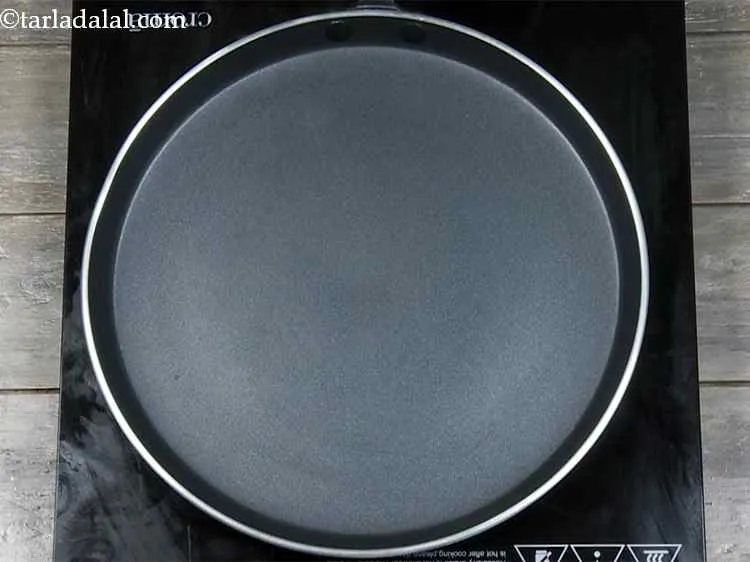 Step 14 – <p>Heat a non-stick tava (griddle), sprinkle a little water on it (it should sizzle immediately) …