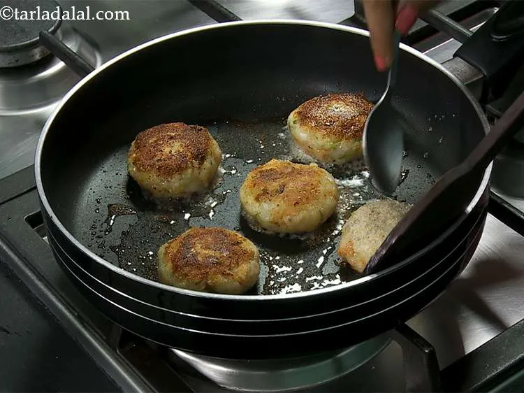 Step 16 – Place 5 cutlets and cook on a medium flame till they turn golden brown in …