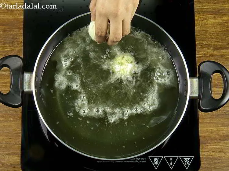 Step 21 – Once the oil is hot, carefully slide in a few broccoli cheese balls. Do not …