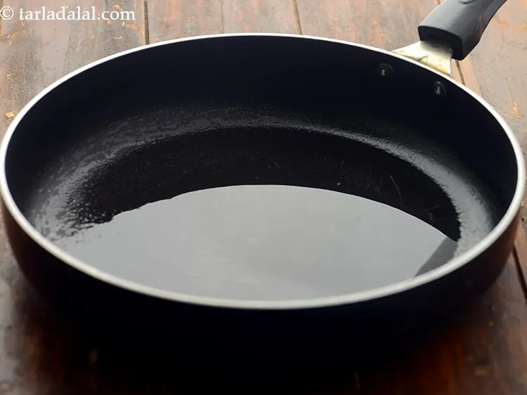 Step 12 – Further for <strong>healthy brown rice vegetable risotto</strong>, heat oil in a broad non-stick pan.