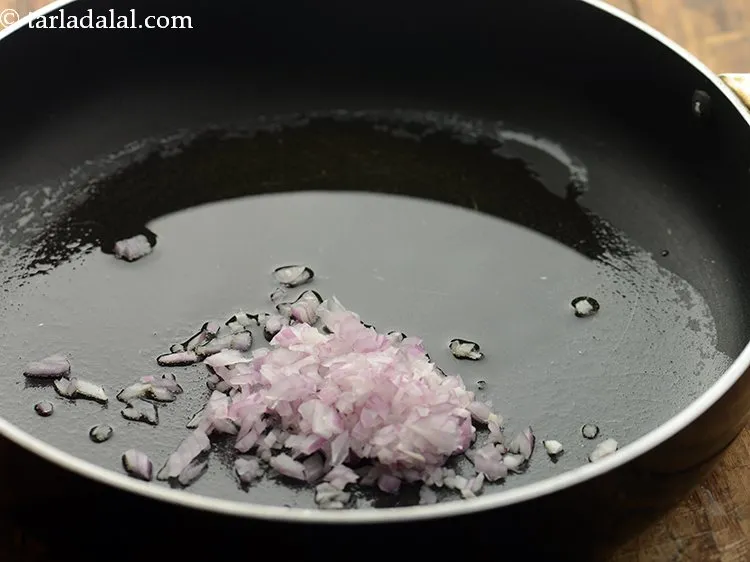 Step 13 – Once the oil is hot, add onions.