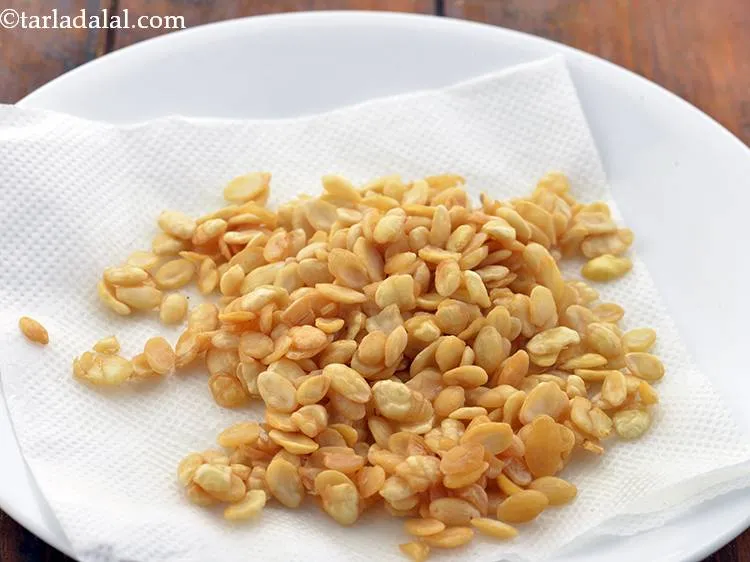 Step 34 – In the same hot oil, add the vaal dal.&nbsp; Deep-fry on a slow flame till …