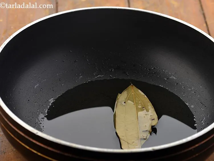 Step 15 – Once the oil is hot, add the bay leaves.