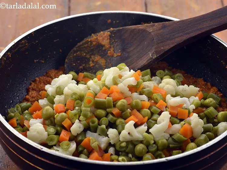 Step 22 – Add the mixed vegetables.