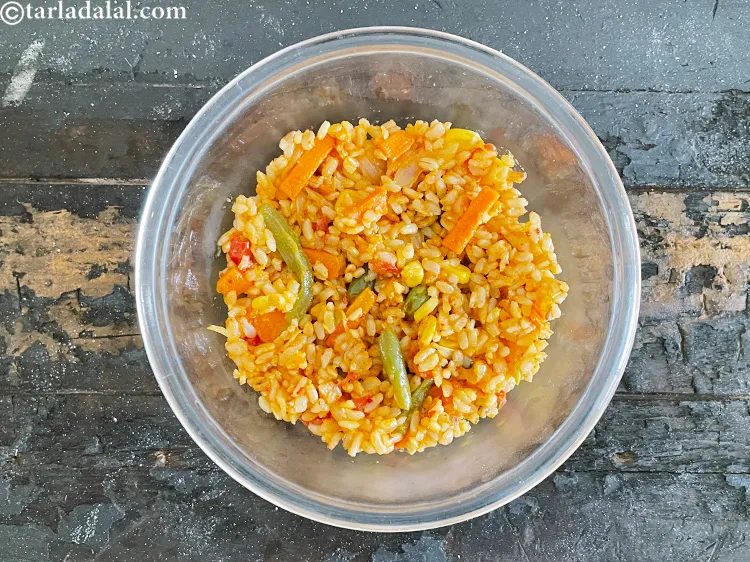 Step 79 – In a deep glass bowl, put Mexican fried rice.
