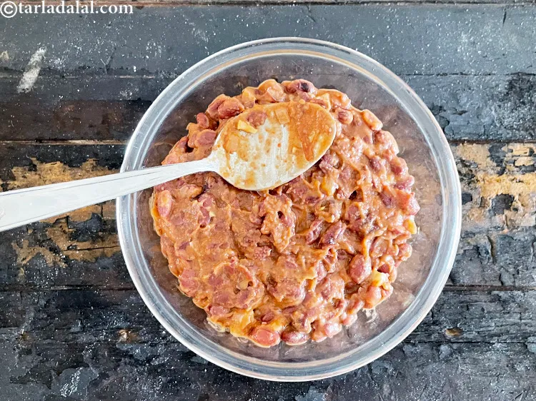 Step 82 – Use the back of a spoon to flatten the refried beans over the Mexican rice.