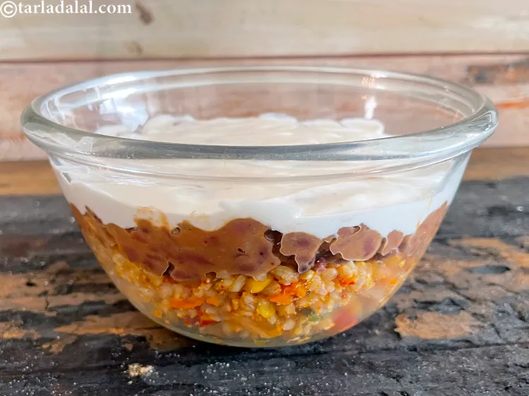 Step 84 – This is a side view of the burrito bowl being made.