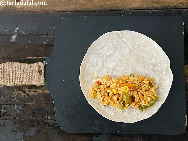 Step 119 – Place &frac34; cup of the Mexican rice on one side of the tortilla. See above …