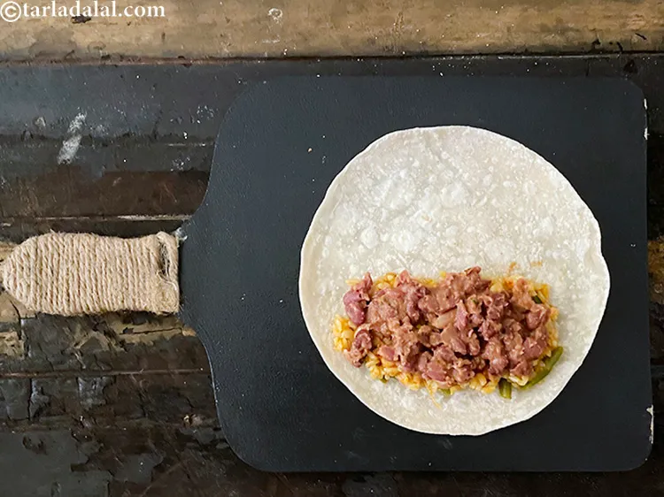 Step 120 – <meta charset="UTF-8" />Put &frac14; cup of refried beans over the rice.
