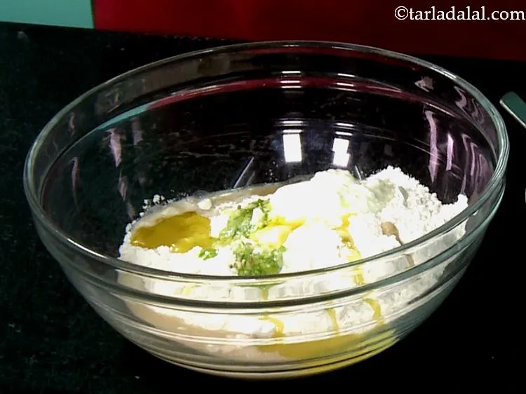 Step 9 – &nbsp;Add the oil. It will help in kneading the dough and will yield softer naans.&nbsp;
