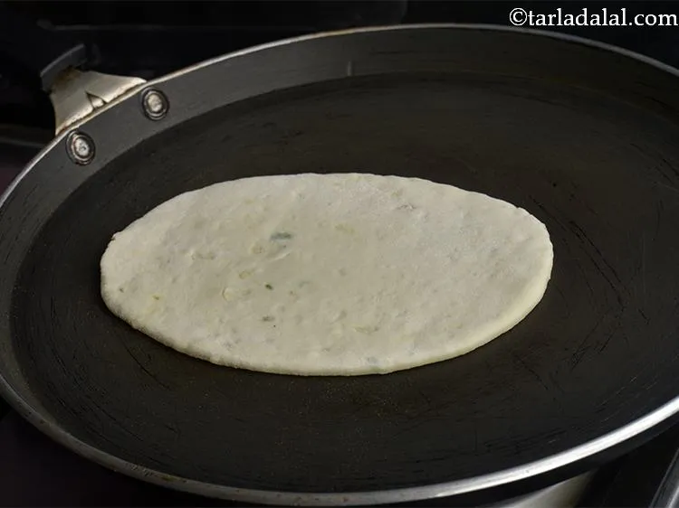 Step 17 – Heat a non-stick tava (griddle) and place the naan over it.