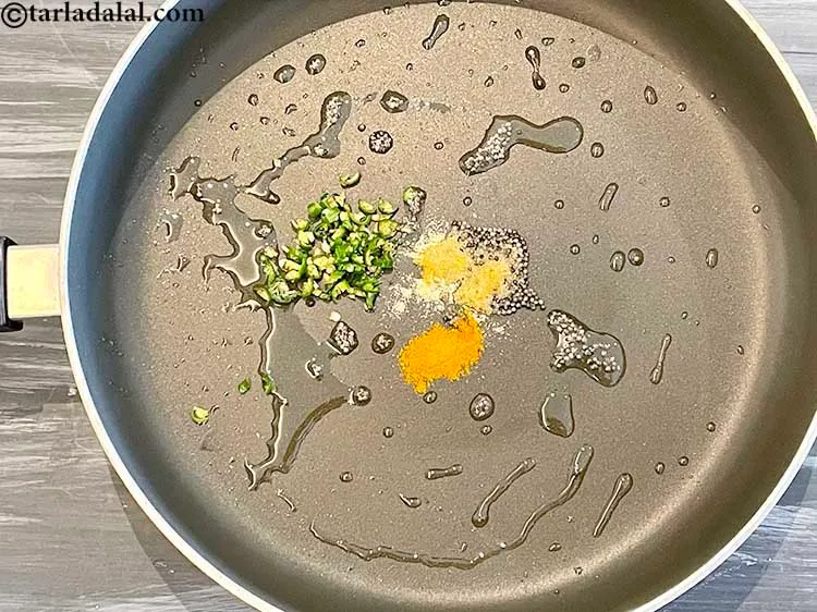 Step 6 – Add the green chillies.&nbsp;Antioxidant&nbsp;<a href="https://www.tarladalal.com/recipes-for-Juices-Rich-in-Vitamin-C-805" target="_blank">vitamin C</a>&nbsp;in&nbsp;<a href="http://www.tarladalal.com/recipes-using-green-chillies-331">green chillies</a>&nbsp;protects the body from effects of harmful …