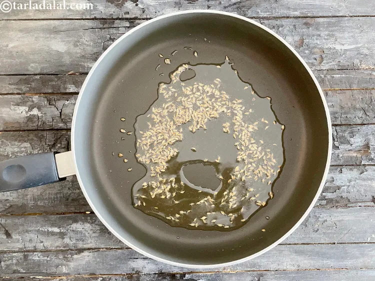 Step 20 – Add&nbsp;<meta charset="UTF-8" />1 tsp&nbsp;<a href="glossary-cumin-seeds-jeera-zeera-381i">cumin seeds (jeera)</a>&nbsp;and let them crackle.