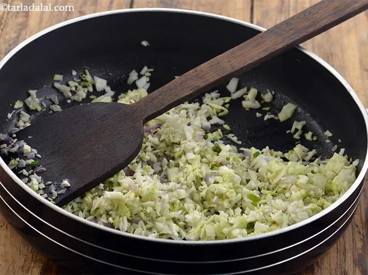 Step 14 – Furthermore, add the cabbage and saut? on a medium flame for another 1 minute.