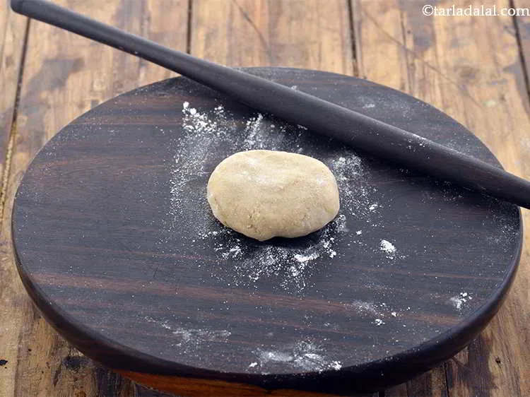 Step 23 – Flatten the ball, dip it in flour and dust off the excess flour.