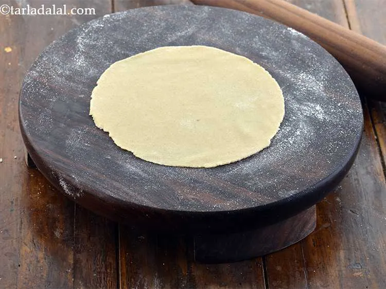 Step 14 – Roll it out into a 125 mm. (5&rdquo;) diameter circle using a little wheat flour …
