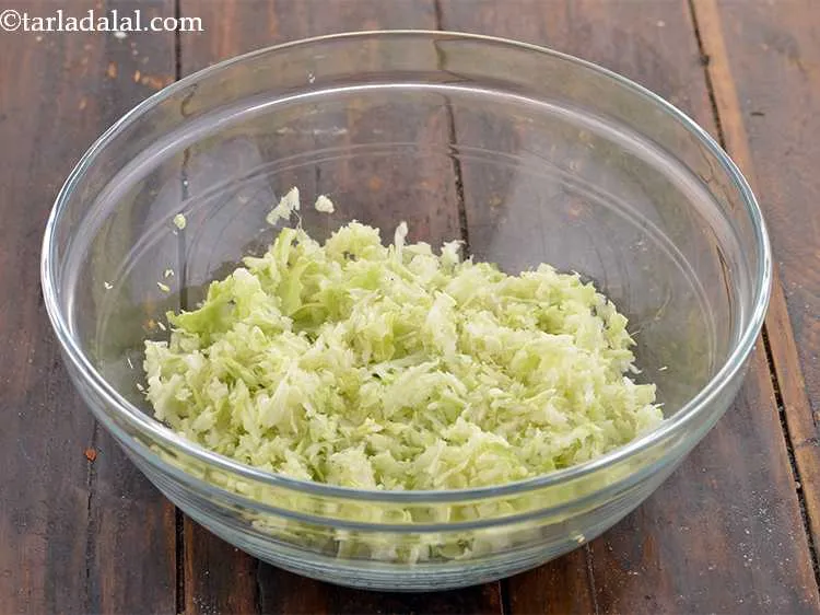 Step 6 – Place the grated cabbage in a deep mixing bowl. Grating the cabbage allows it mix …