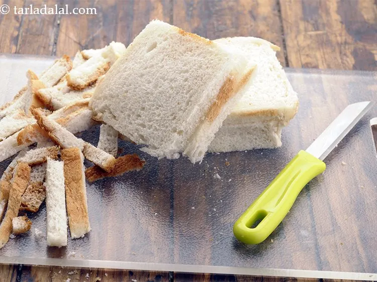 Step 13 – Place the bread slice on a clean, dry chopping board and remove the crust using …