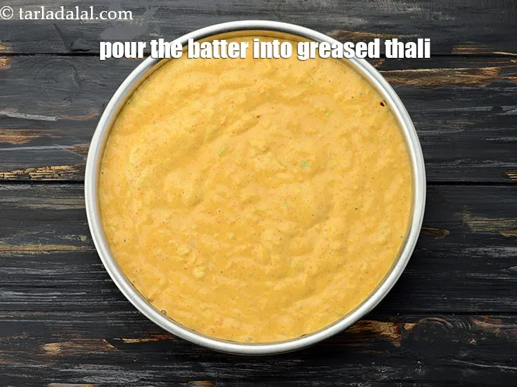 Step 18 – Pour the batter into a greased 175 mm. (7&rdquo;) diameter thali.